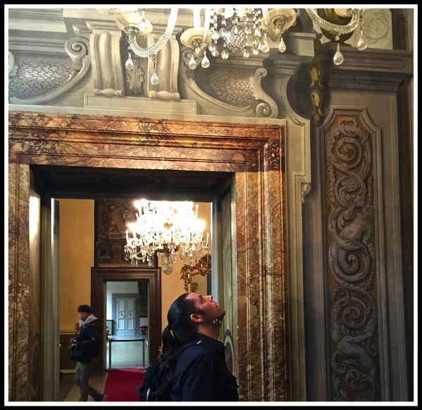 A photo of me looking upwards towards some amazingly designed door frames!